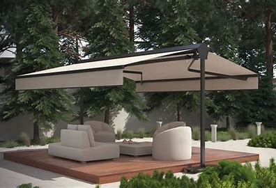 terrace with armchairs, awning and parasol